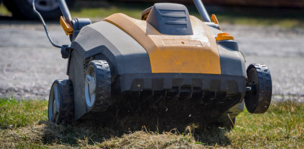 Gardener Operating Soil Aeration Machine on Grass Lawn