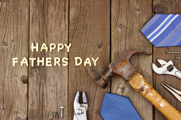 istock Happy Fathers Day wood letters with tools and ties on rustic wood 952048578