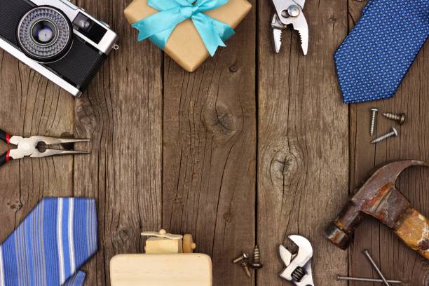 istock Fathers Day frame of gifts, ties and tools on rustic wood 952049178