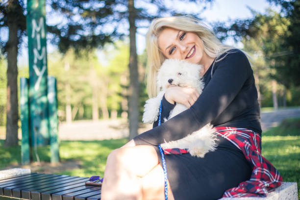 Young woman with poodle puppy.