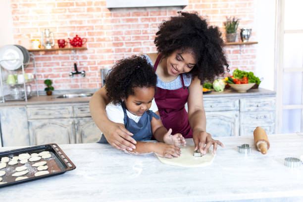 istock Mother and daughter making cookies at home 952058918