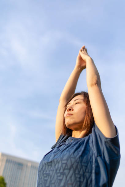 istock Japanese woman practicing yoga under the sky 952059546