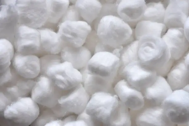 A close up image of white fluffy cotton swabs.