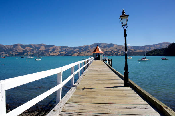 Akaroa pier on beautiful day South Island New Zealand stock photo