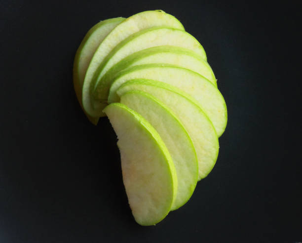 istock Green apple cut isolated on a black background 952060214