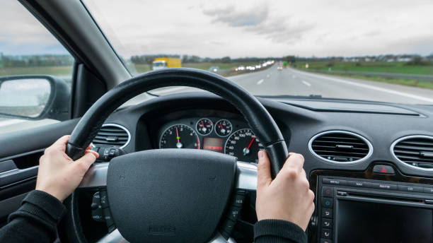 istock Young woman driving fast fast car on motorway 952060648