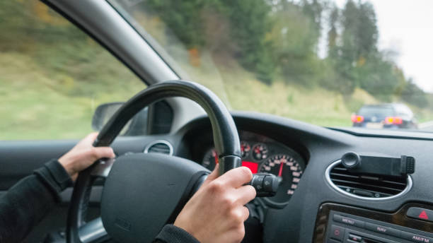 istock Young woman driving on motorway 952060842