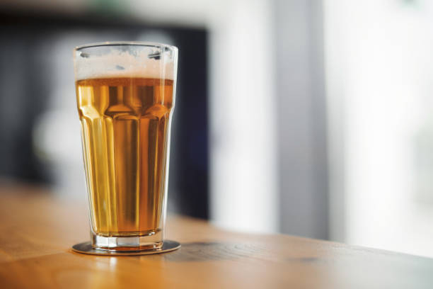 istock Beer glass stands on bar counter. 952061076
