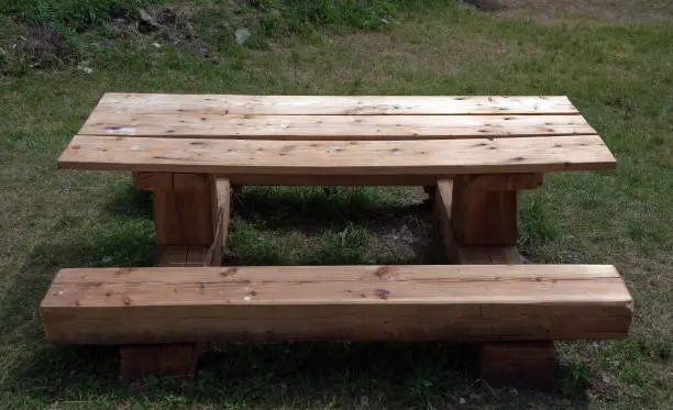A picnic table constructed off heavy timbers.