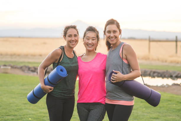 istock Three Women Holding Yoga Mats 952062686