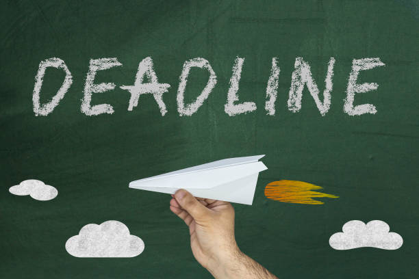 istock hand holding paper airplane and Deadline text 952062918