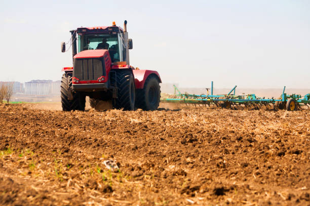 istock Farmer in tractor preparing land with seedbed cultivator 952066132