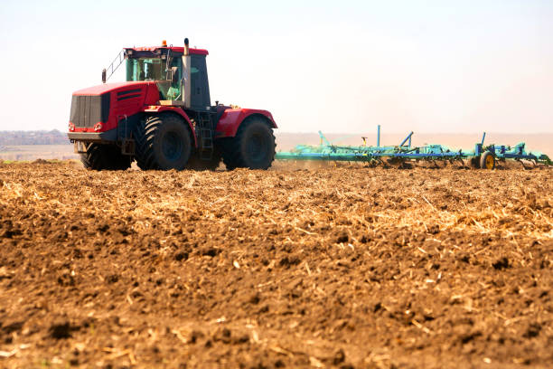 istock Farmer in tractor preparing land with seedbed cultivator 952066156
