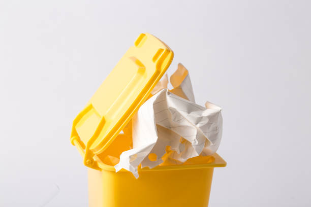 istock yellow plastic trash bin from paper isolated on white 952068126