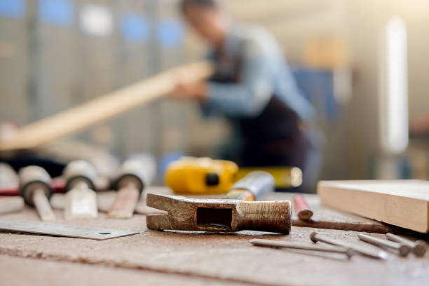 istock equipment on wooden desk with man working in workshop background. 952068610