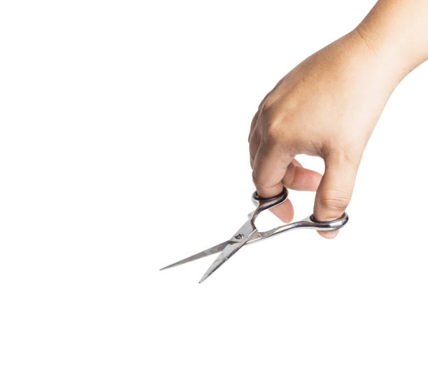 istock Woman hand is holding scissors isolated on white background. File contains a clipping path. 952071114