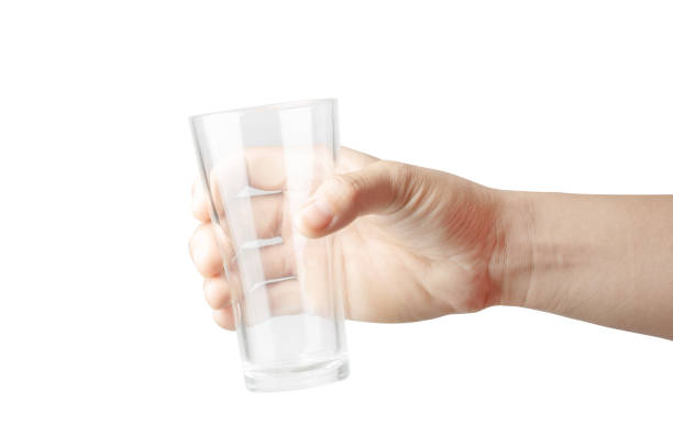 istock Woman hand is holding empty glass isolated on white background. File contains a clipping path. 952071118