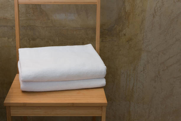 istock White towels on wood table. 952072344