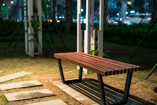 istock Wooden bench in the park at night 952075024