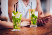 Close-up of mojito cocktails served at summer beach bar