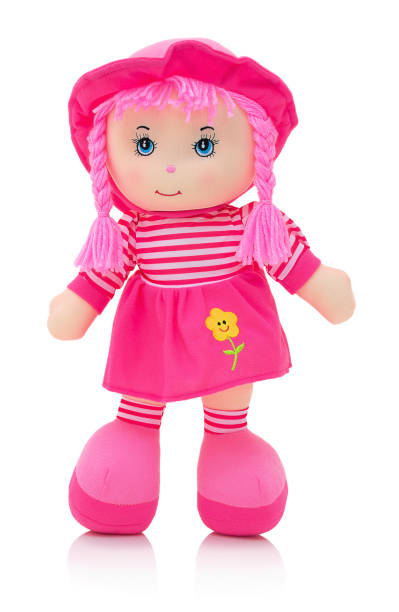 istock Pinky plushie doll isolated on white background with shadow reflection. Cute rag baby doll isolated on white background with shadow reflection. Pinky doll on white backdrop. Nice contemporary rag baby with pink hair. Modern joyfully rag baby with cap. 952081464