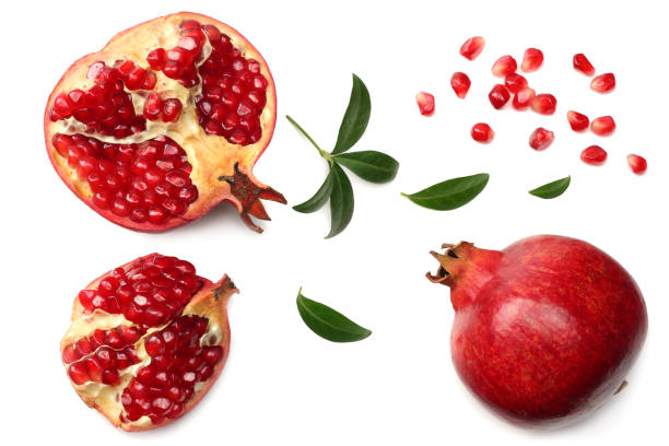 istock pomegranate fruit with seeds and green leaves isolated on white background top view 952084130