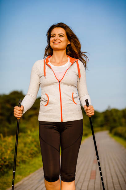 istock Nordic walking - young woman training outdoor 952086508