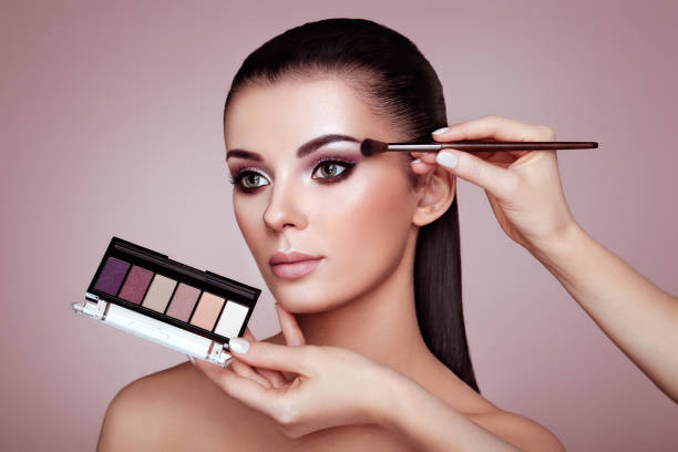 istock Makeup artist applies eye shadow 952087226