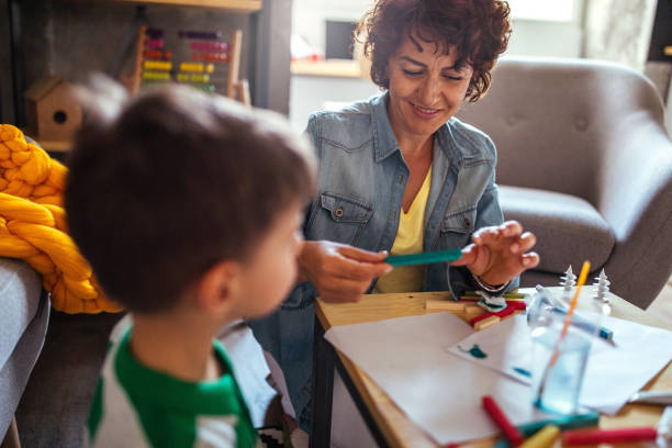 istock Mother and son coloring together 952090340