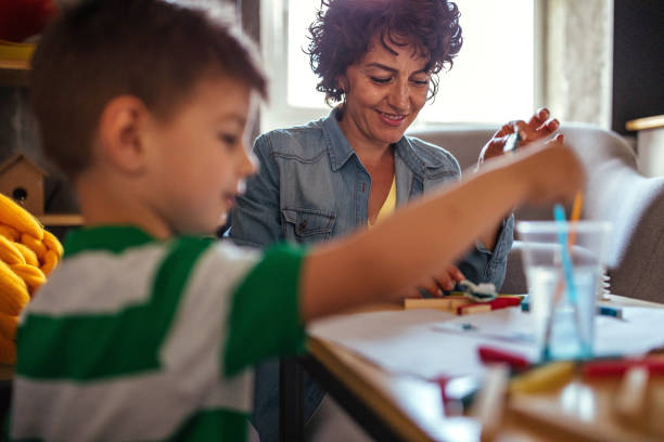 istock Mother and son coloring together 952090418