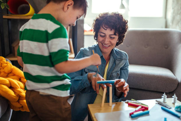 istock Mother and son coloring together 952090456