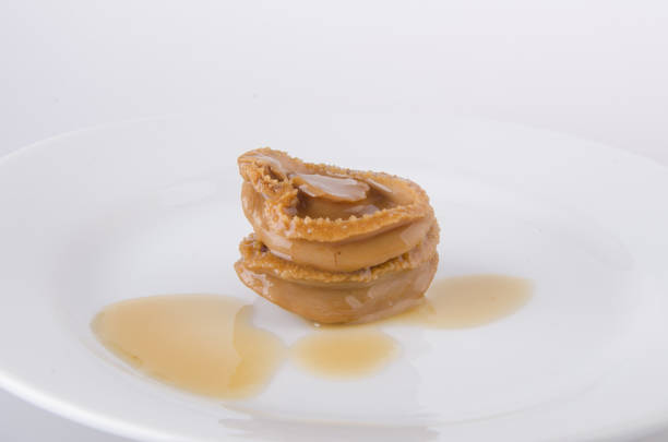 istock Abalones. Chinese cuisine abalone on the background. 952094734