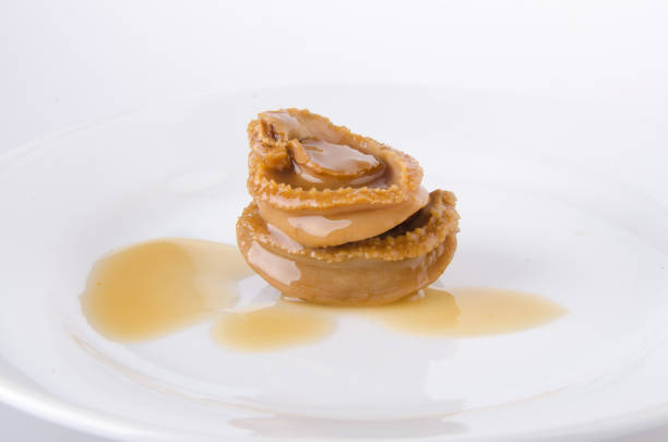 istock Abalones. Chinese cuisine abalone on the background. 952094752