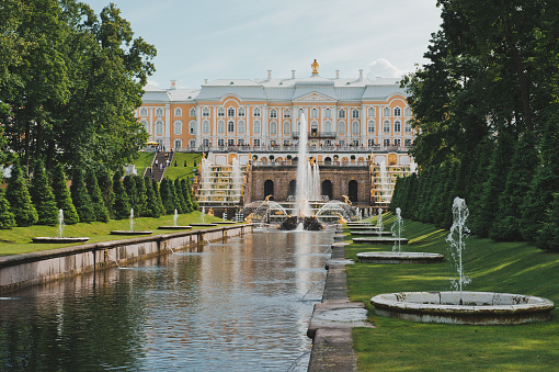 View of the Big Peterhof palace and the cascade of fountains from the sea near to the city of St. Petersburg.