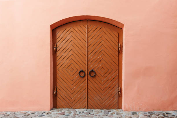 Ancient wooden door in the wall, brown. Texture