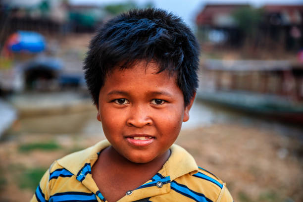 Portrait of happy Cambodian little boy, Cambodia Portrait of happy Cambodian little boy near Tonle Sap, Cambodia cambodian ethnicity stock pictures, royalty-free photos & images