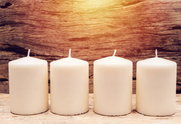 istock group of white candle with wooden background 952099704