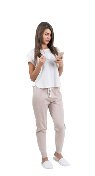 istock Young woman with coffee and phone 952103100