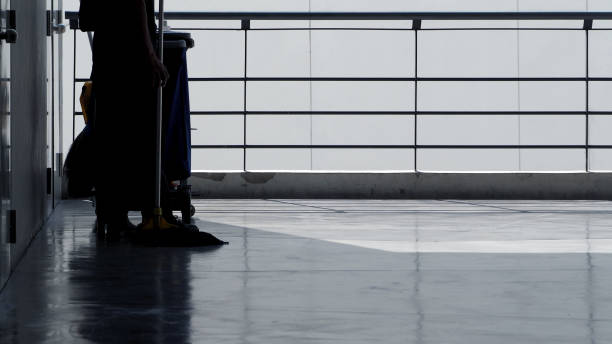 istock Silhouette image of cleaning service people sweeping floor with mop 952104306