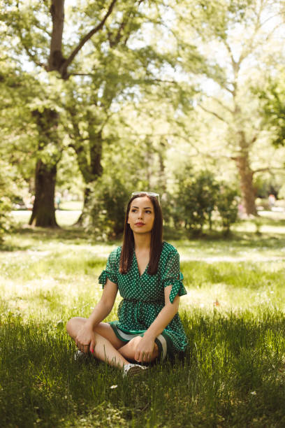 istock Young woman meditating in the park 952105564