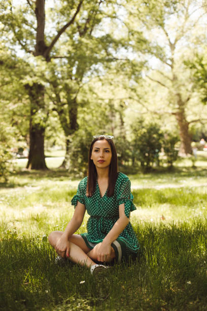istock Young woman meditating in the park 952105852