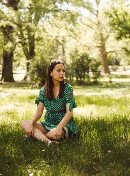 istock Young woman meditating in the park 952105980