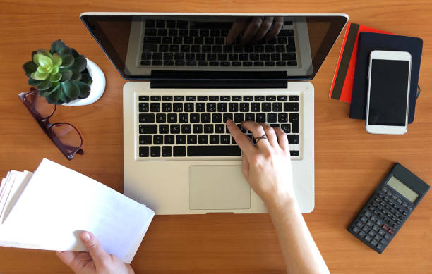 istock Woman working on laptop top view 952108268