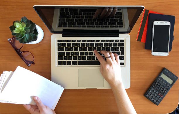 istock Woman working on laptop top view 952108322