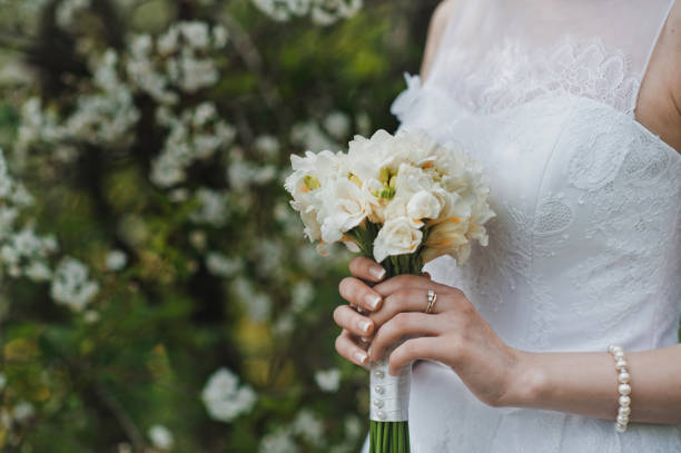 istock Bunch of flowers in hands 1284. 952111100