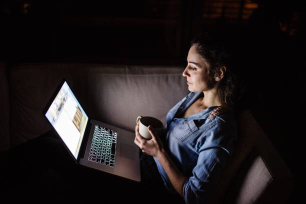 istock A woman working on a laptop at night. 952112378