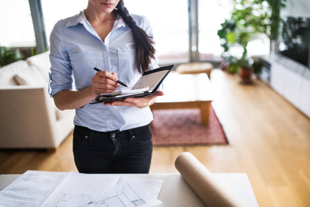 istock Young woman using a personal diary at home. 952112566