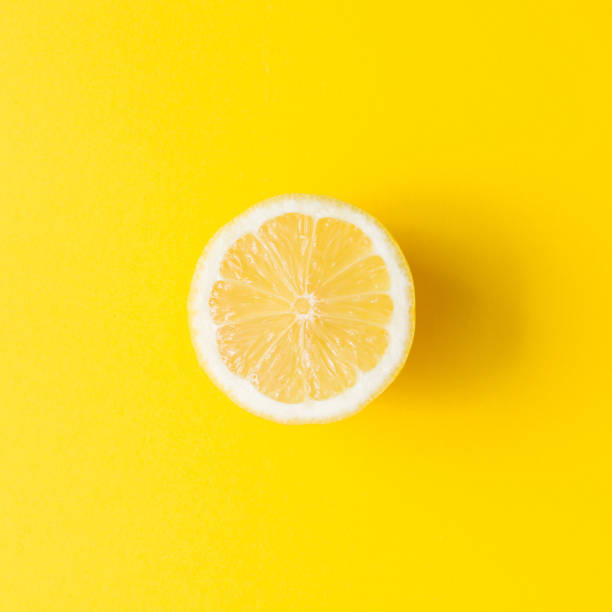 istock Lemon on vivid yellow background. Minimal summer concept. Flat lay. 952114856