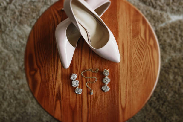 istock bride's biege shoes on heel on a carpet. 952117402