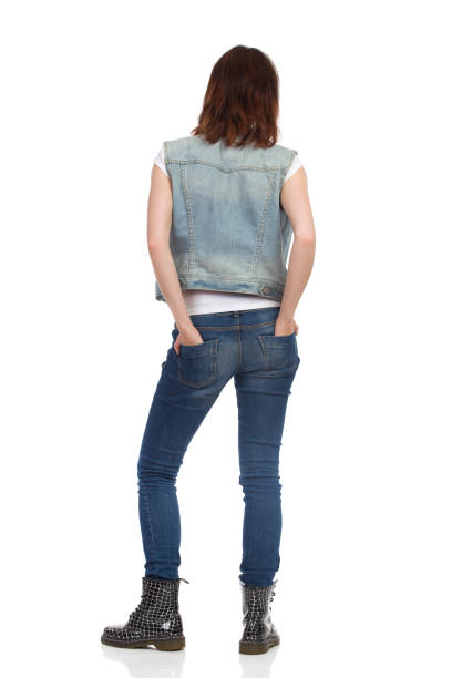Young Relaxed Woman Is Standing. Rear View.